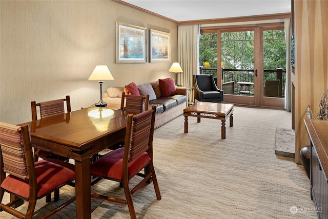 dining space with light colored carpet and crown molding