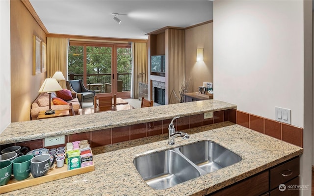 kitchen with sink and light stone countertops