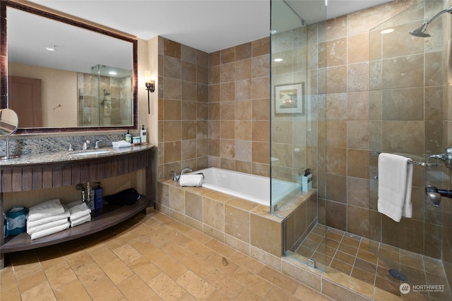 bathroom featuring tile walls, vanity, and plus walk in shower