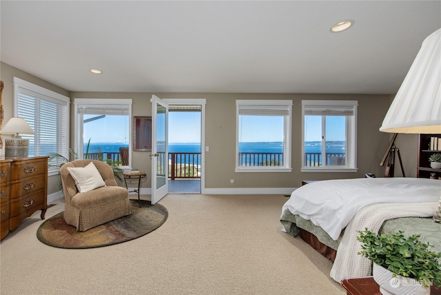 carpeted bedroom featuring baseboards, recessed lighting, and access to exterior