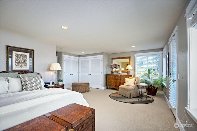 carpeted bedroom with baseboards, multiple closets, and recessed lighting