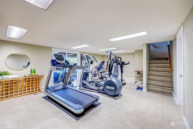 workout area with tile patterned floors and baseboards