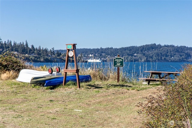 exterior space featuring a water view and a view of trees