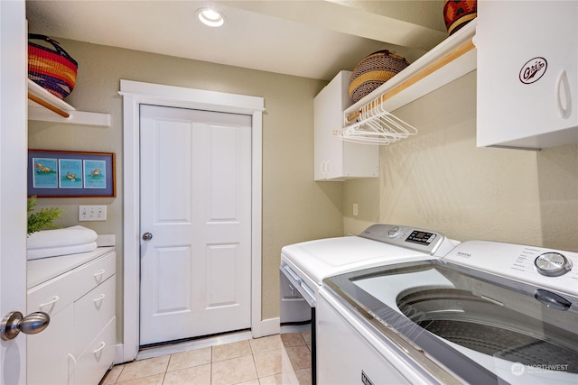 laundry room featuring light tile patterned floors, washing machine and clothes dryer, cabinet space, and recessed lighting