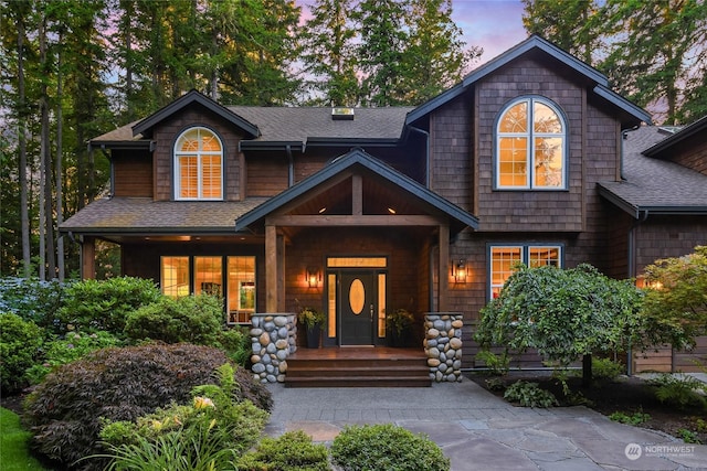 view of front of home featuring roof with shingles