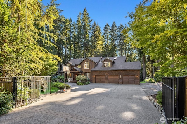 rustic home with driveway, an attached garage, and fence