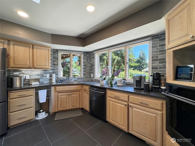 kitchen with backsplash, light brown cabinets, and black appliances