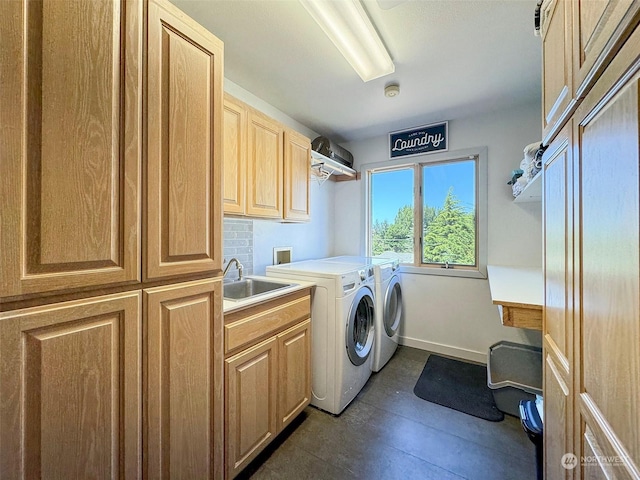 laundry area with washer and dryer, cabinet space, baseboards, and a sink