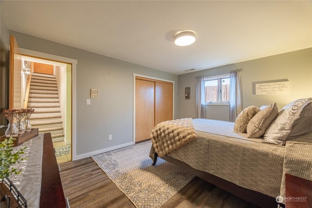 100 Ridgetop Pl, Sequim, WA 98382 - bedroom with a closet, baseboards, and wood finished floors