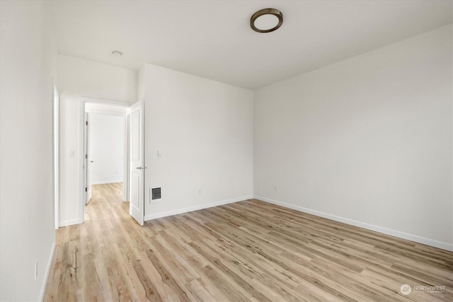 spare room with light hardwood / wood-style flooring
