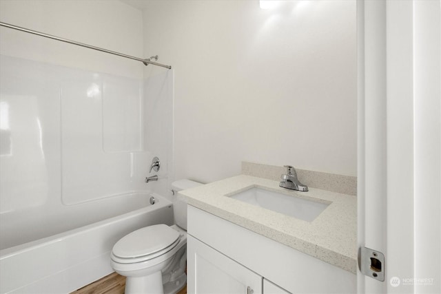 full bathroom featuring hardwood / wood-style flooring, vanity, toilet, and  shower combination