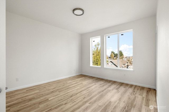 unfurnished room with light wood-type flooring