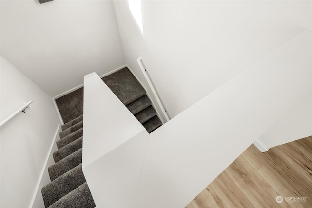staircase with wood-type flooring