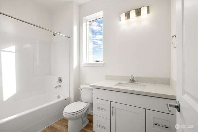 full bathroom featuring vanity, toilet, shower / washtub combination, and wood-type flooring
