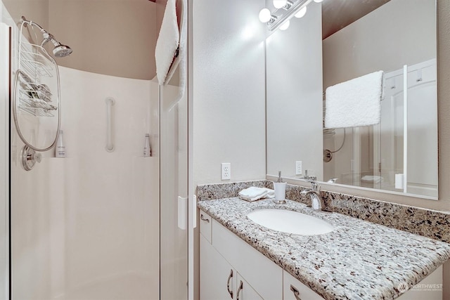 bathroom with a shower and vanity