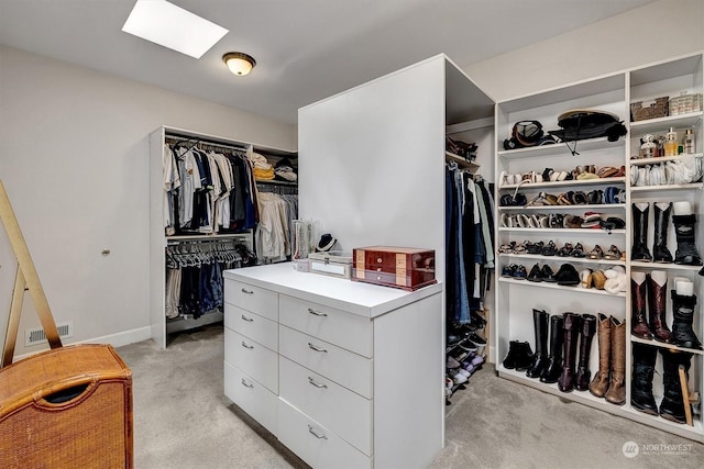 spacious closet featuring light carpet