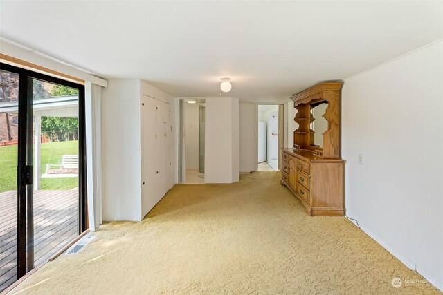 unfurnished living room featuring light colored carpet