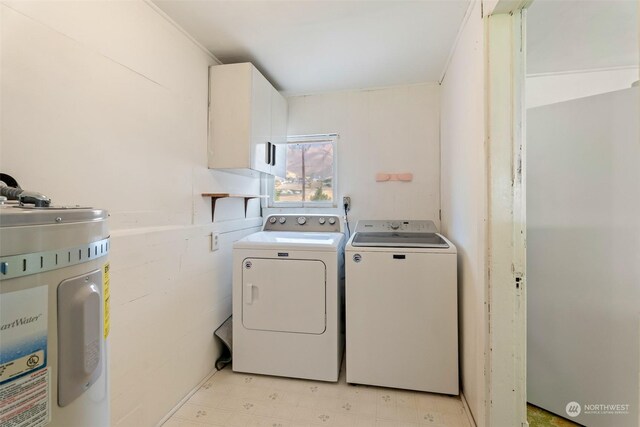 clothes washing area with water heater and washer and dryer