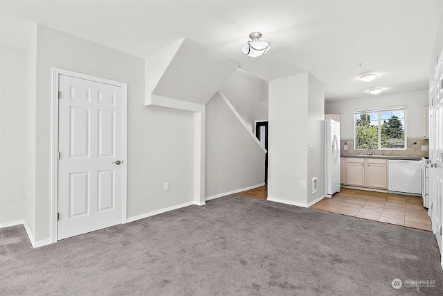 interior space featuring sink and light colored carpet