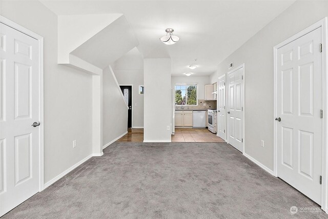 interior space with sink and light colored carpet