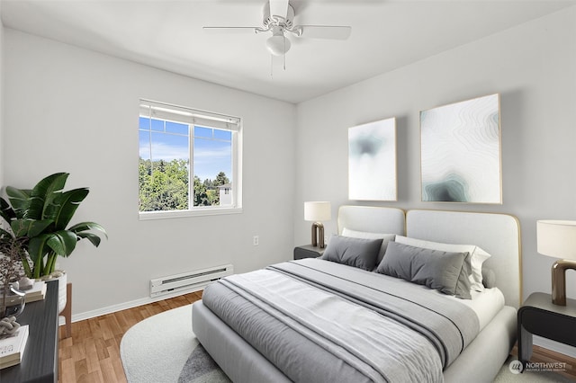 bedroom with a baseboard radiator, hardwood / wood-style floors, and ceiling fan