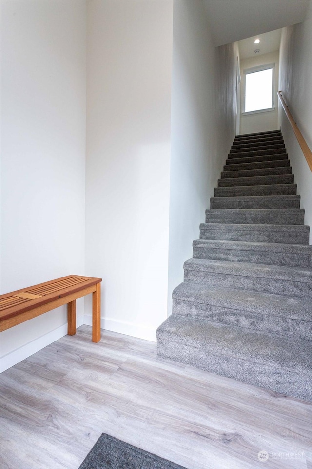 stairs with wood-type flooring