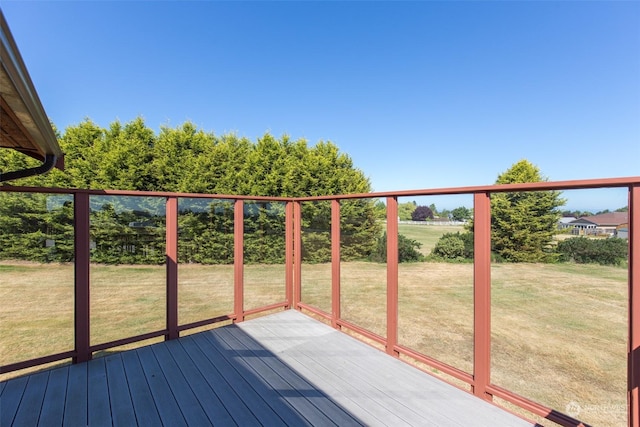 wooden terrace featuring a yard