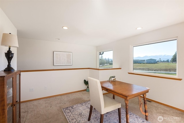 carpeted dining room featuring a mountain view