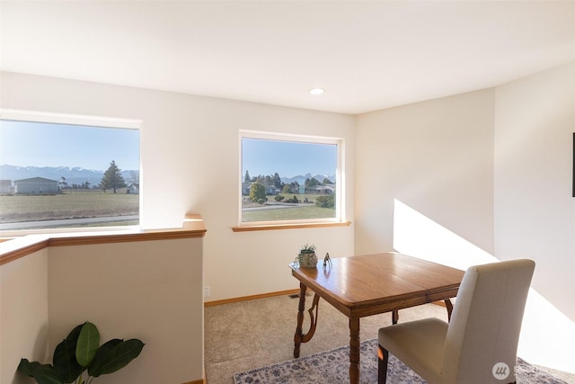 office area with a mountain view, carpet floors, and a wealth of natural light