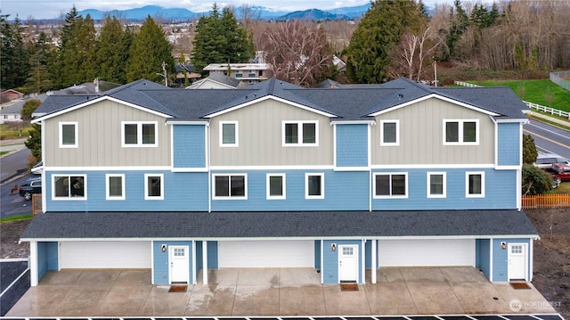 view of front of property with a mountain view and a garage