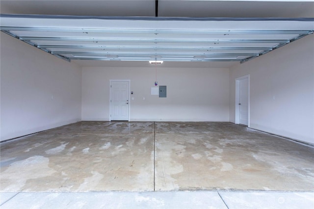 garage with a garage door opener and electric panel