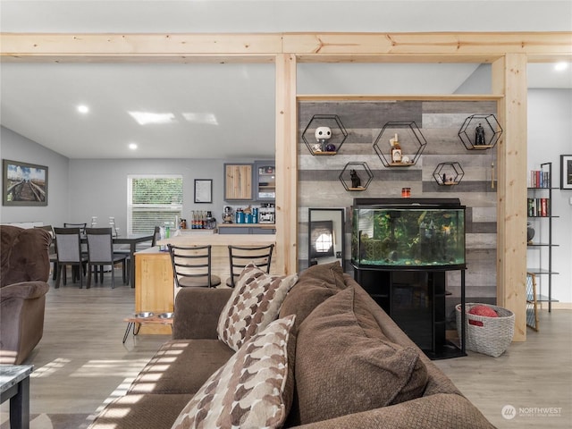 living room with wood-type flooring and lofted ceiling