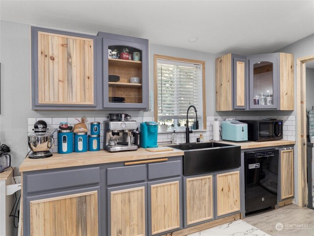 kitchen featuring backsplash, gray cabinetry, light brown cabinets, and black appliances