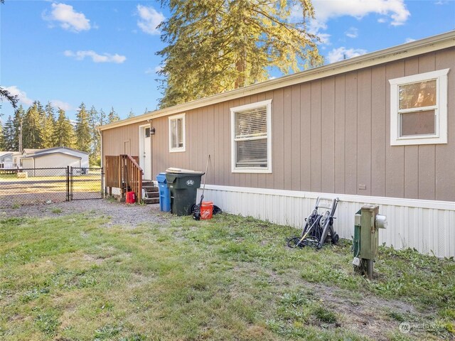 view of side of property with a lawn