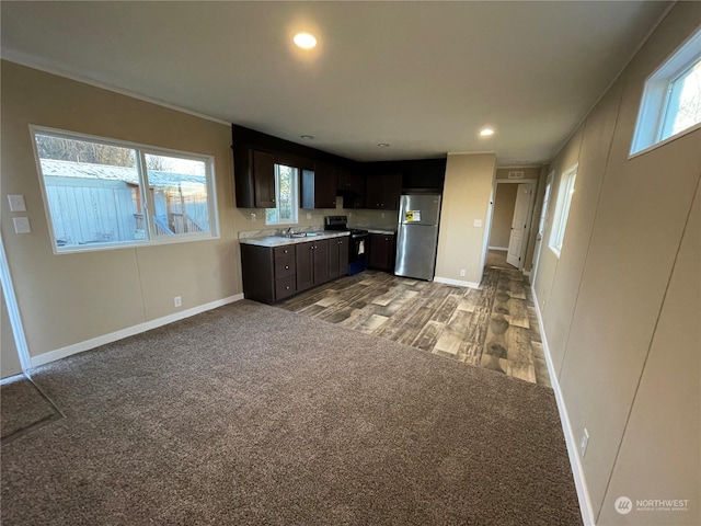 kitchen with stainless steel refrigerator, carpet floors, black electric range oven, sink, and dark brown cabinets