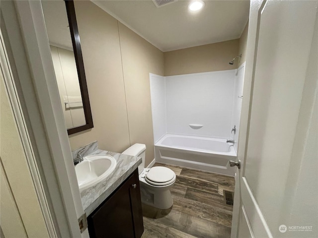 full bathroom with vanity, shower / bathing tub combination, hardwood / wood-style flooring, and toilet