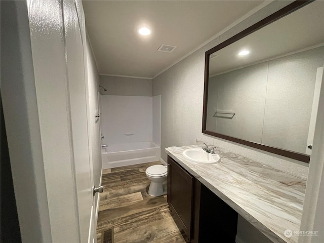 full bathroom with toilet, crown molding, wood-type flooring, shower / washtub combination, and vanity