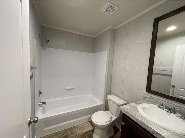 full bathroom with shower / washtub combination, hardwood / wood-style floors, ornamental molding, vanity, and toilet