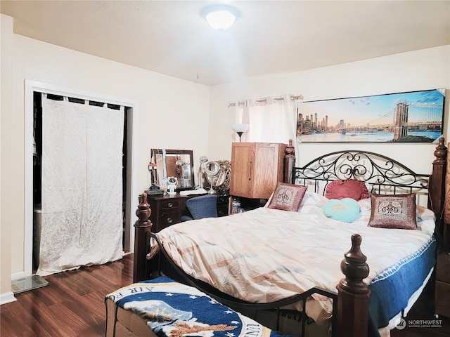 bedroom with dark hardwood / wood-style floors