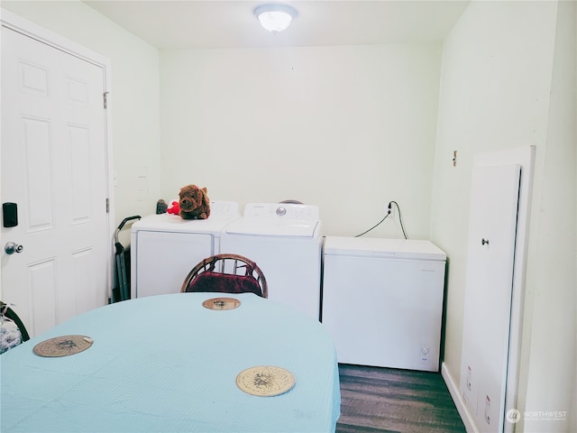 clothes washing area featuring washing machine and dryer and dark hardwood / wood-style floors