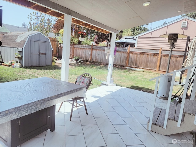 view of patio with exterior bar and a storage unit