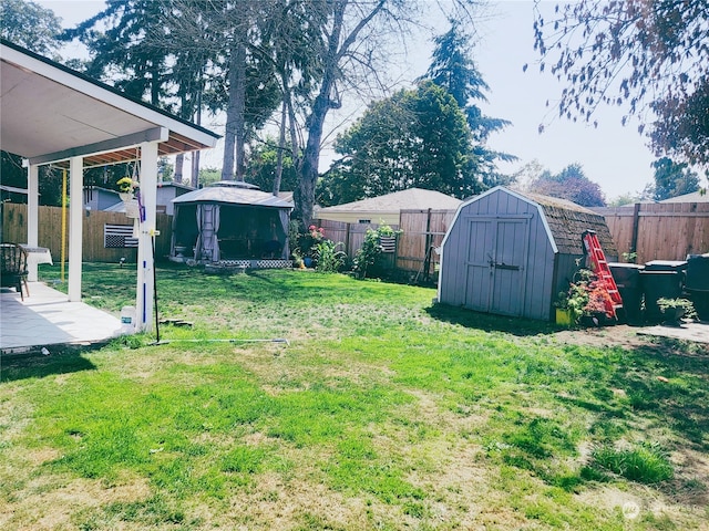 view of yard featuring a gazebo, a patio, and a storage unit