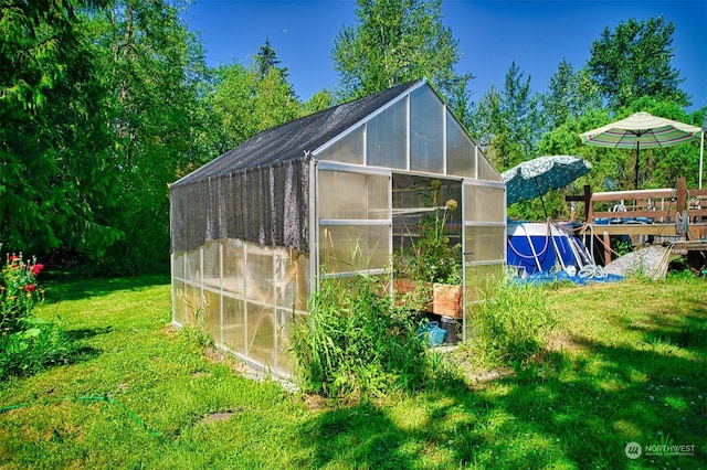 view of outbuilding featuring a lawn