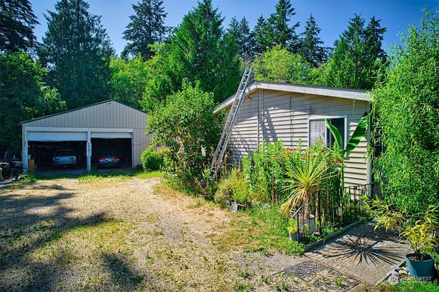 view of home's exterior with an outdoor structure and a garage