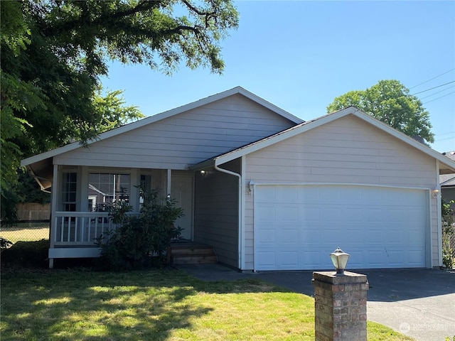 view of front facade with driveway, a front lawn, a porch, fence, and an attached garage