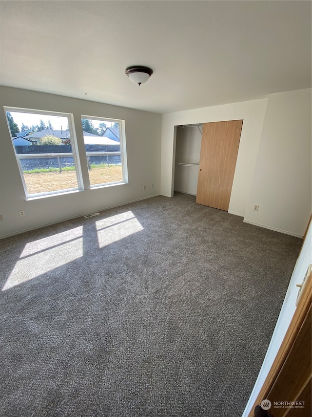 unfurnished bedroom featuring carpet floors and a closet