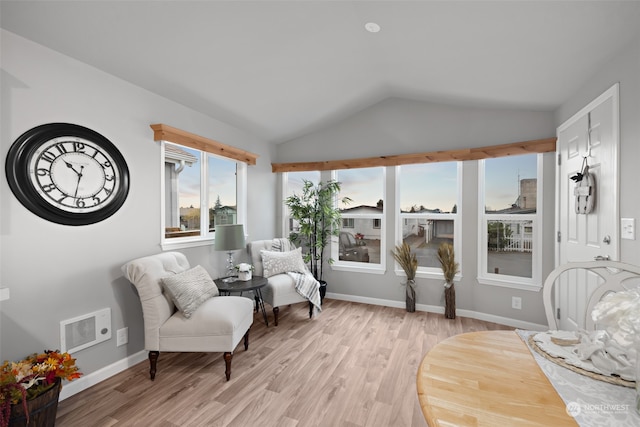 sitting room with light hardwood / wood-style flooring and vaulted ceiling