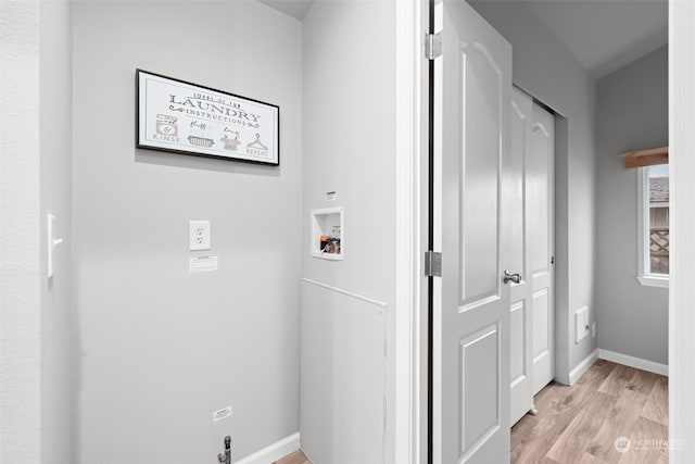 clothes washing area with washer hookup and light hardwood / wood-style floors