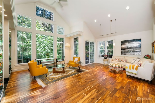 sunroom / solarium with lofted ceiling and a ceiling fan