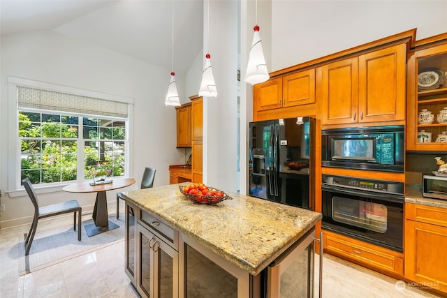 kitchen featuring black appliances, pendant lighting, lofted ceiling, light tile patterned flooring, and a center island